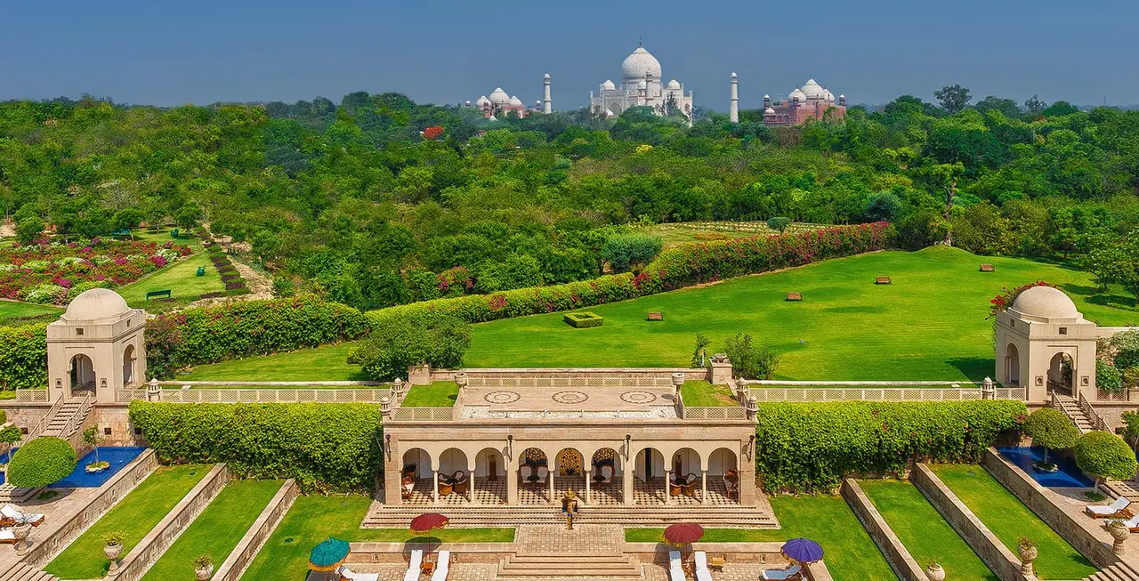 The Taj Mahal beyond the woods, above the resort’s terraced gardens with their pavilions and pools