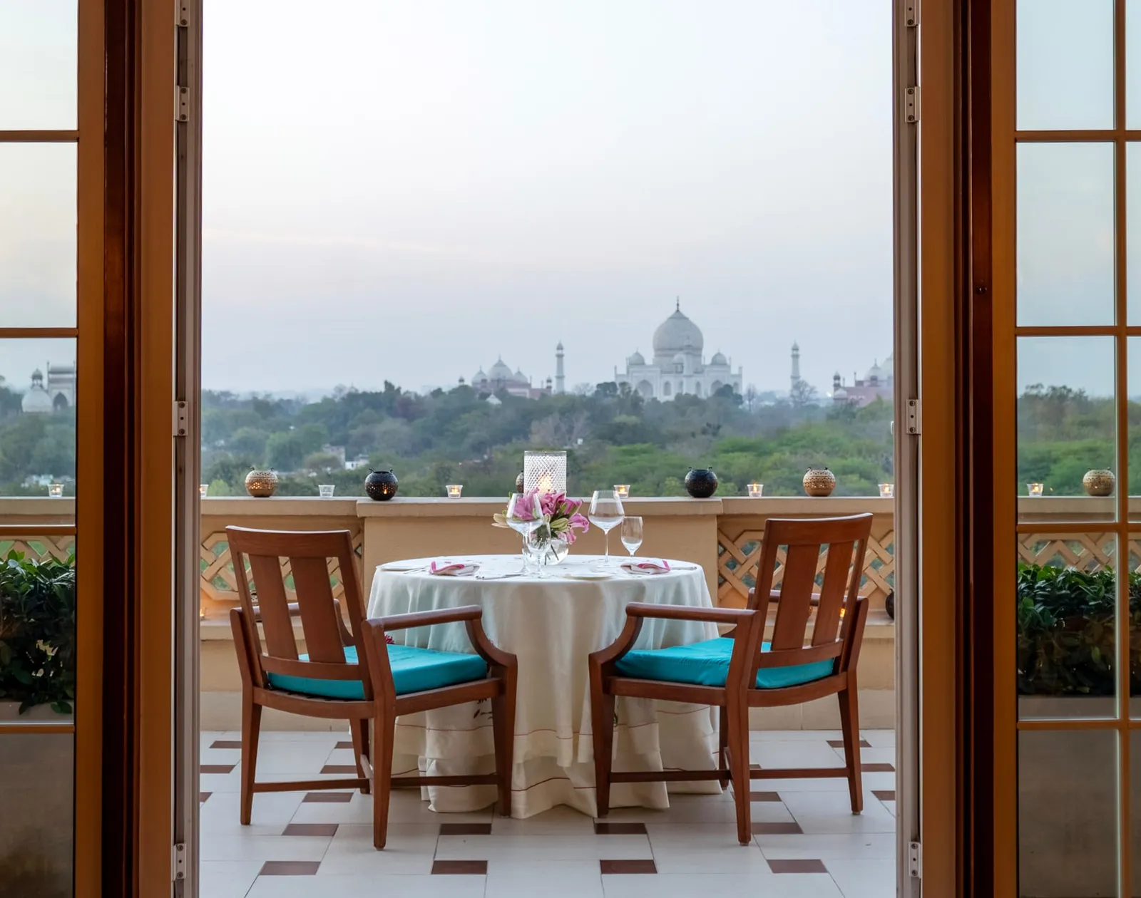 A table for 2 on the Kohinoor Suite’s balcony, the Taj Mahal beyond the balustrade