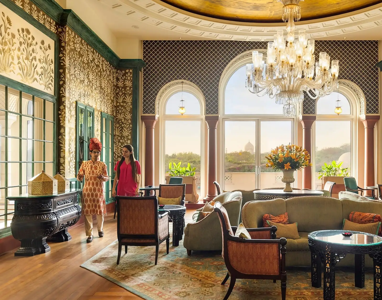 The Lounge with its crystal chandelier and arched windows, the Taj Mahal visible beyond them