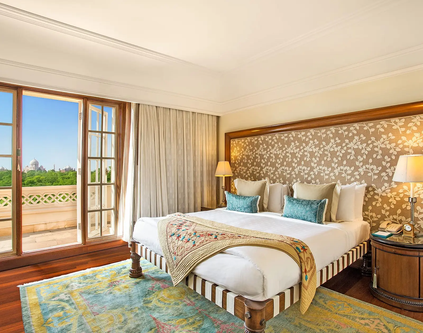 A Deluxe Suite with Balcony’s bedroom, its king bed and the balcony beyond the French window