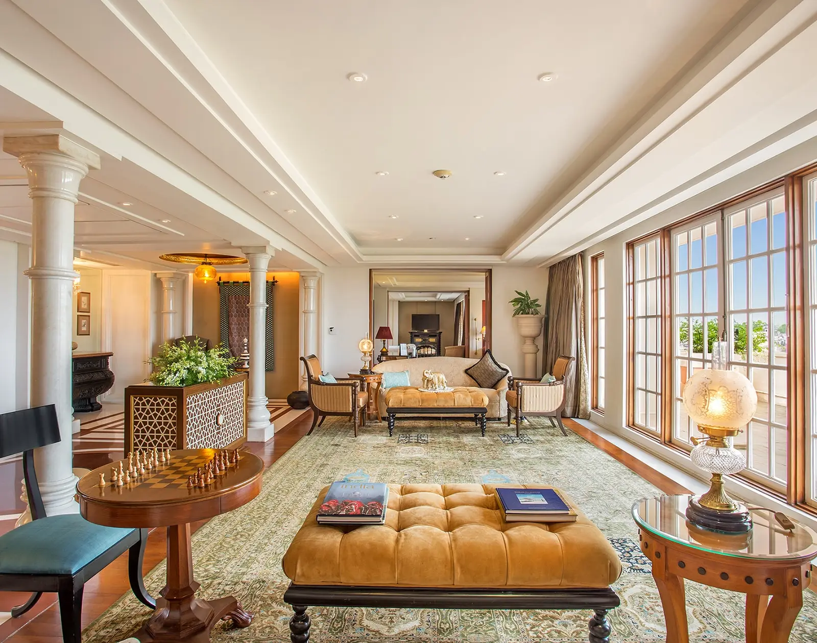 The Kohinoor Suite’s living room with marble columns, a chessboard and windows onto the Taj Mahal