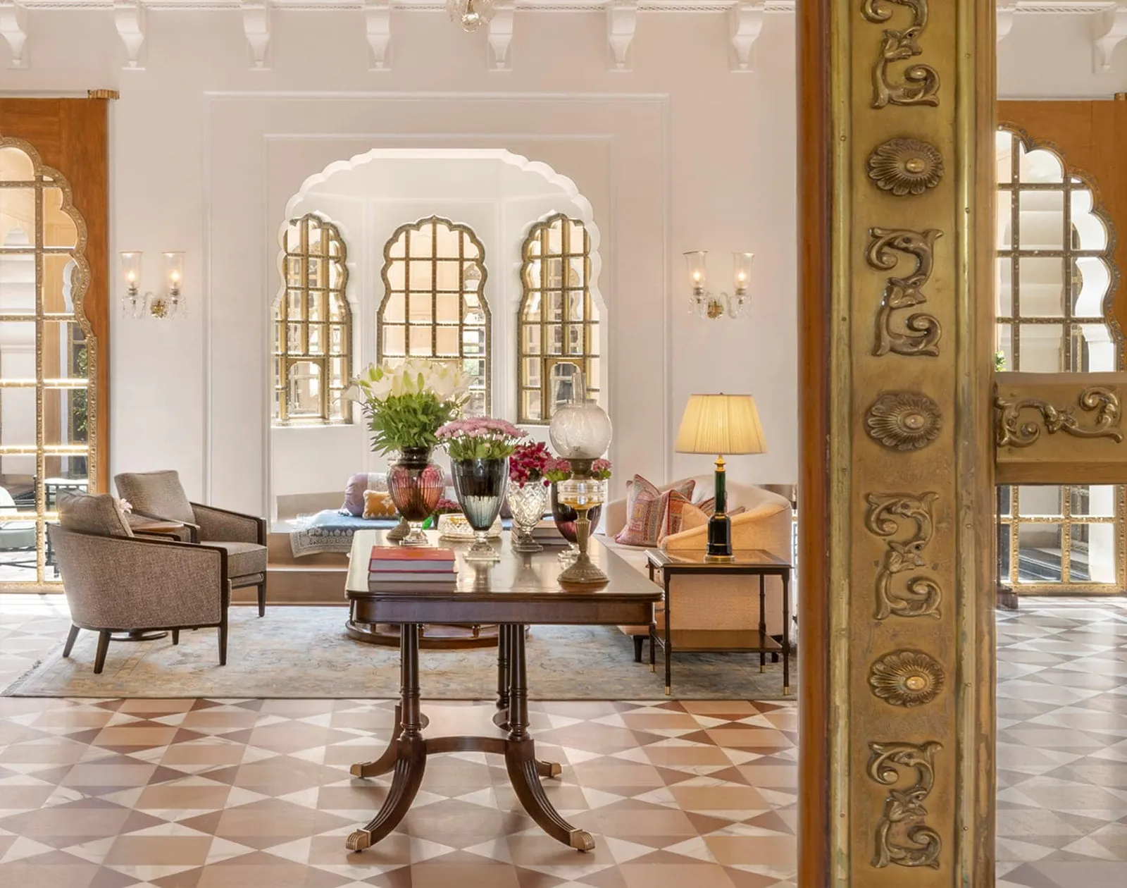 The entrance lounge with its diamond-patterned floor, armchairs and chandelier