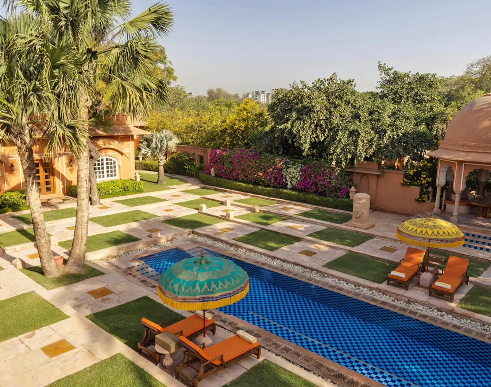 The Kohinoor Villa’s pool from above, with parasols and lawn