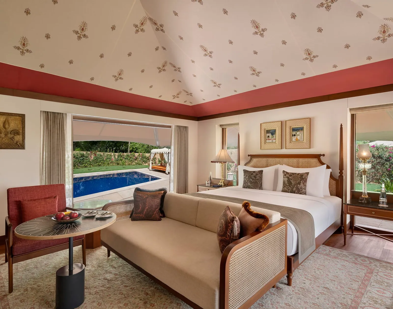 A Luxury Tent with its king bed and the private pool beyond the glass