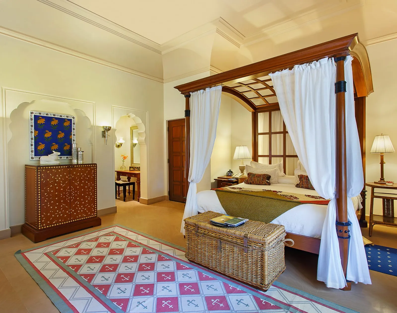 A Premier Room with a four-poster bed, a chest and windows on the garden