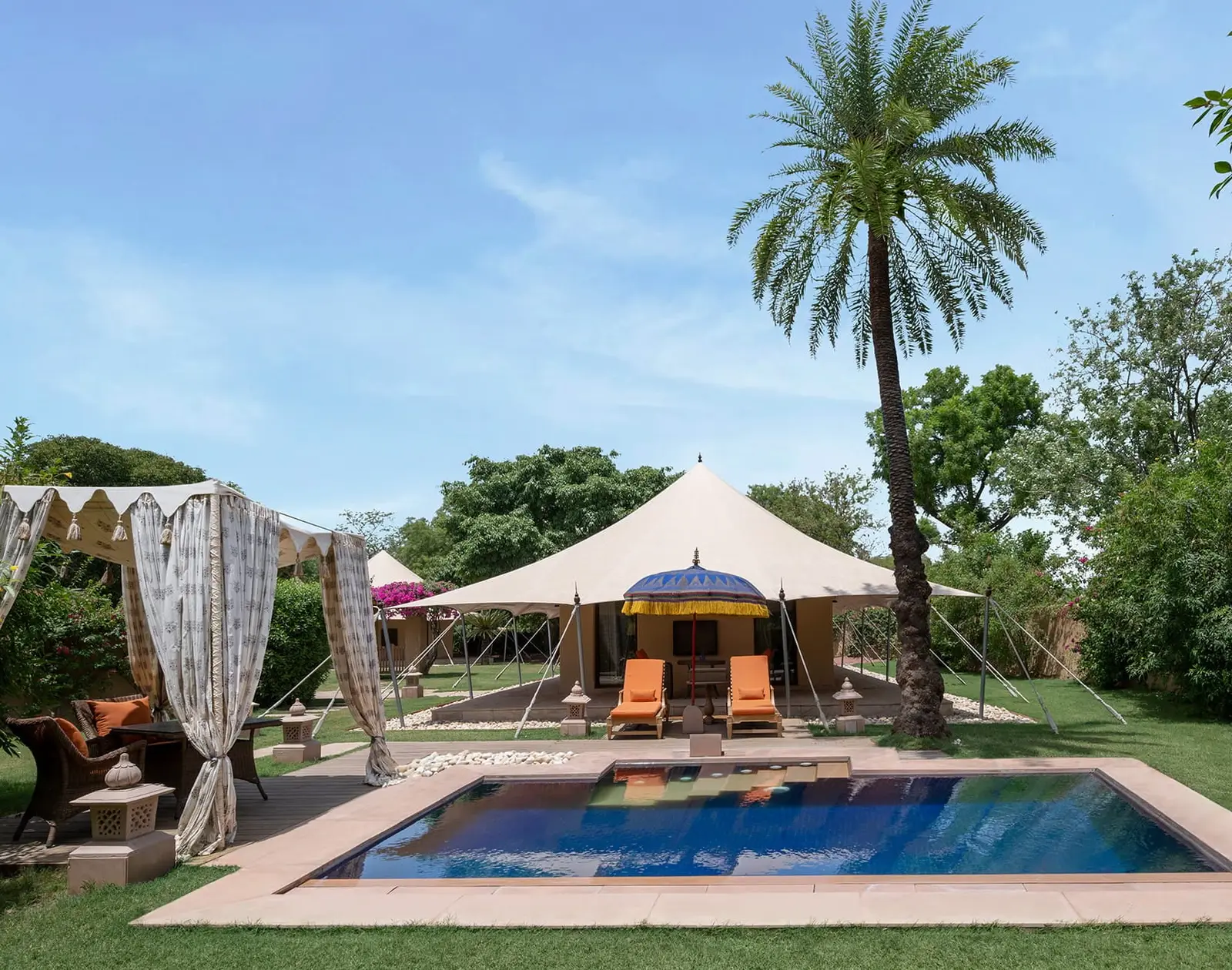 The Royal Tent on its lawn, with the private pool and orange loungers