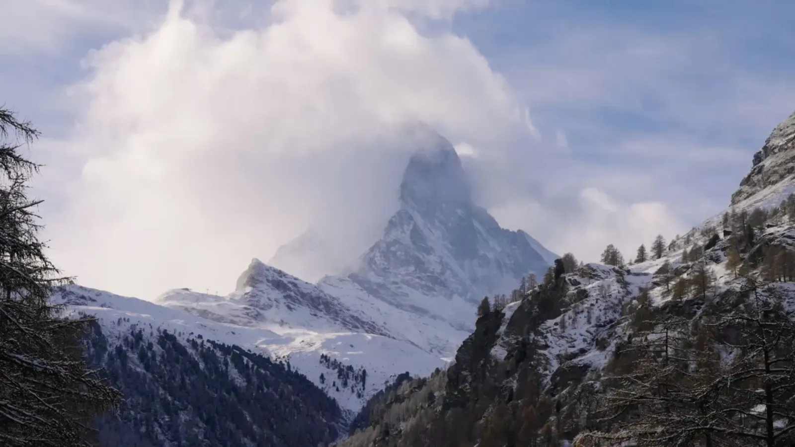 The Matterhorn amid clouds above the valley
