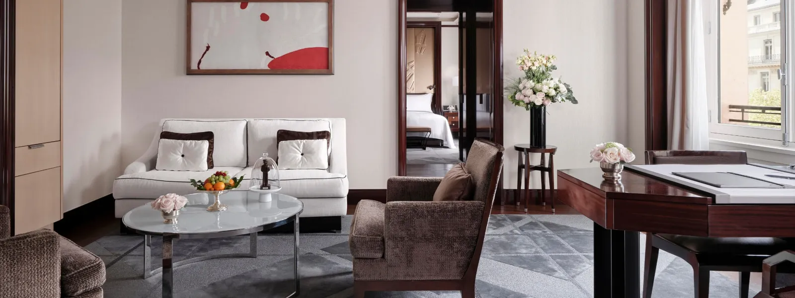 The Deluxe Suite living room with a sofa, armchairs and coffee table