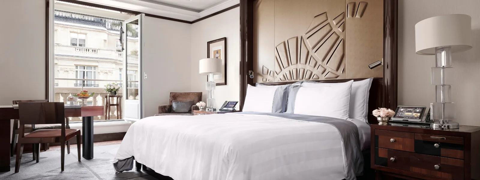 Grand Premier Room with a double bed, lamps and table beside the windows