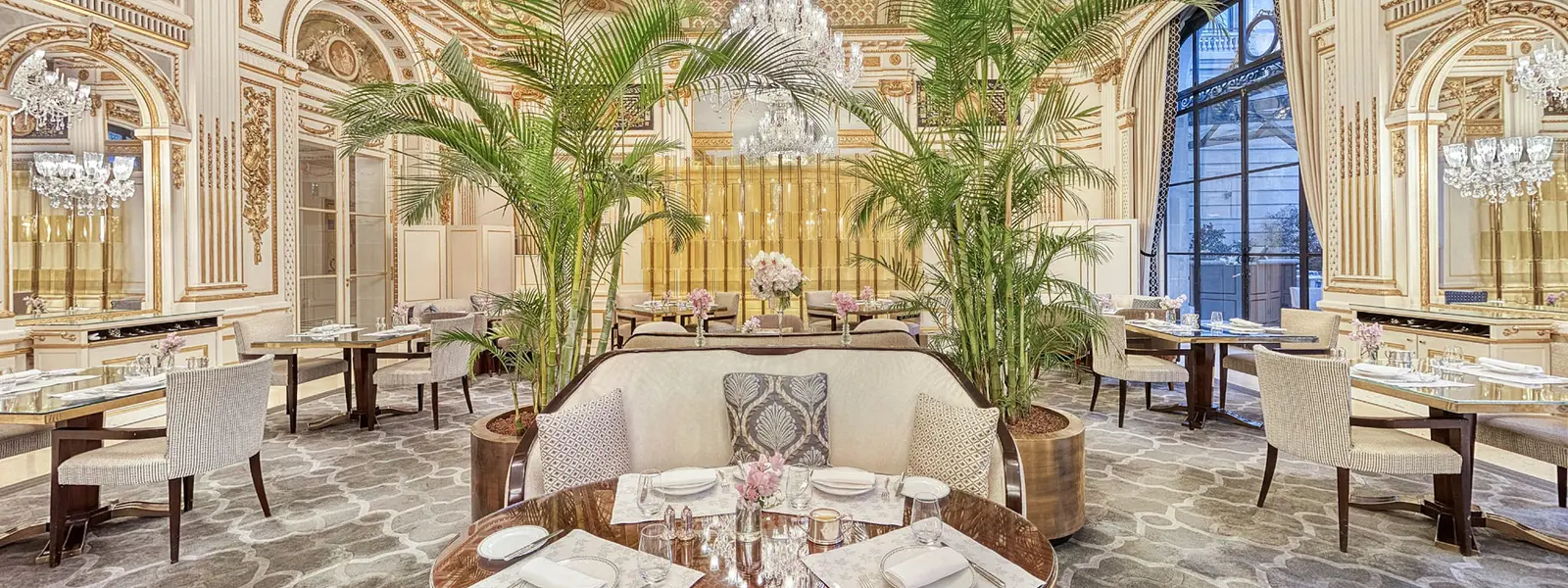 Le Lobby with mirrors, gilded decoration, chandeliers and laid tables