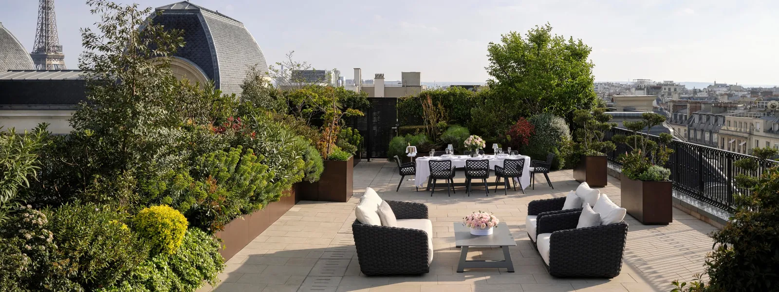 The Katara Suite terrace with planting, outdoor seating and a dining table