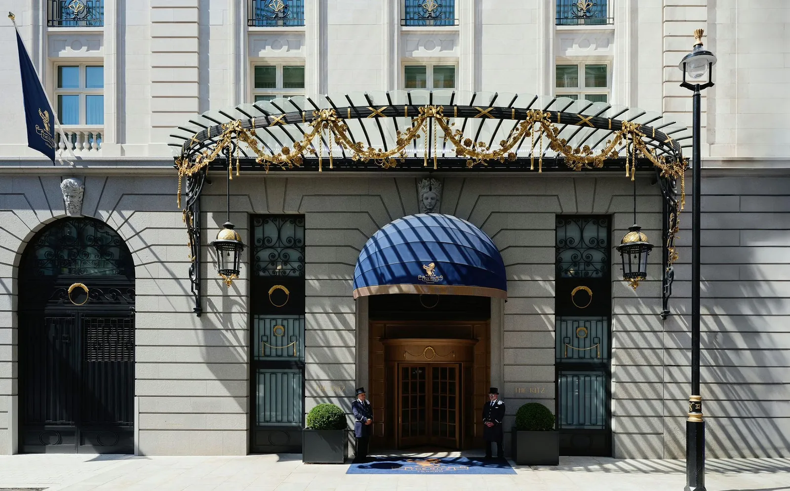 The Ritz’s entrance, with its wrought-iron canopy and blue awning