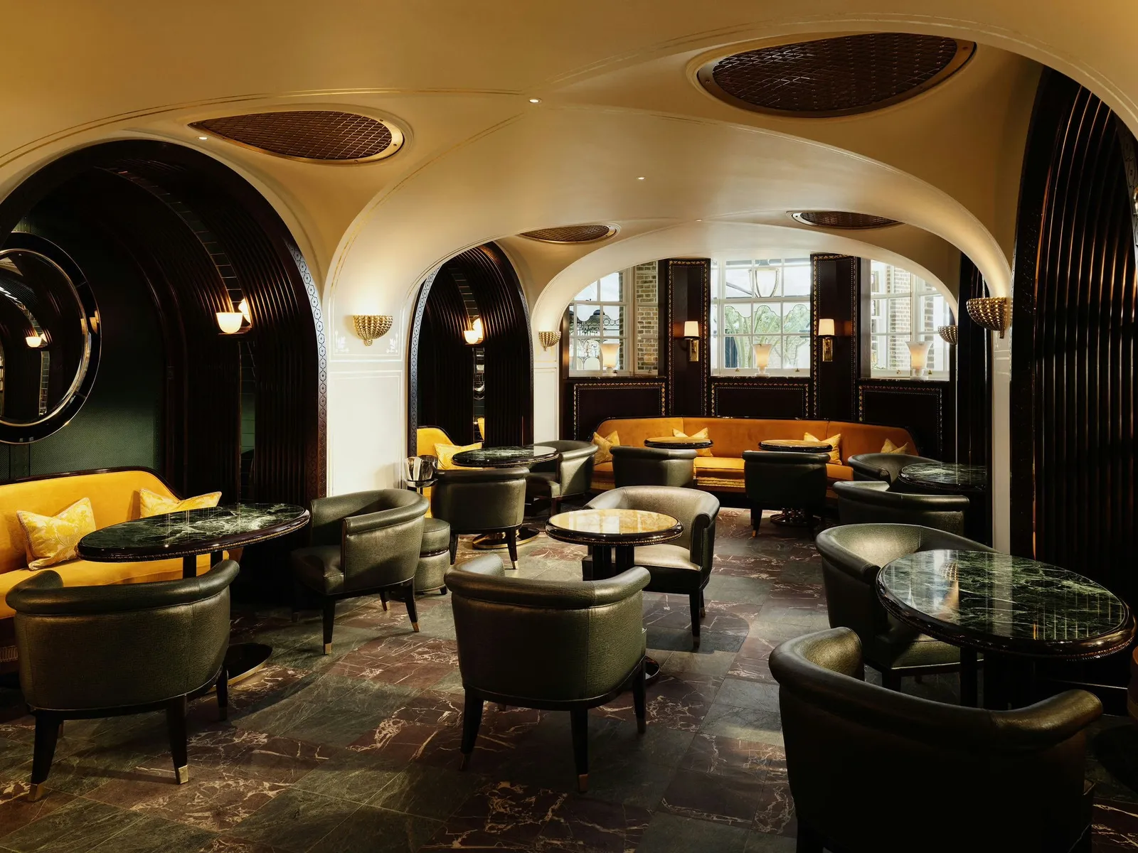 The Rivoli Bar: white arches, green leather armchairs and mustard banquettes