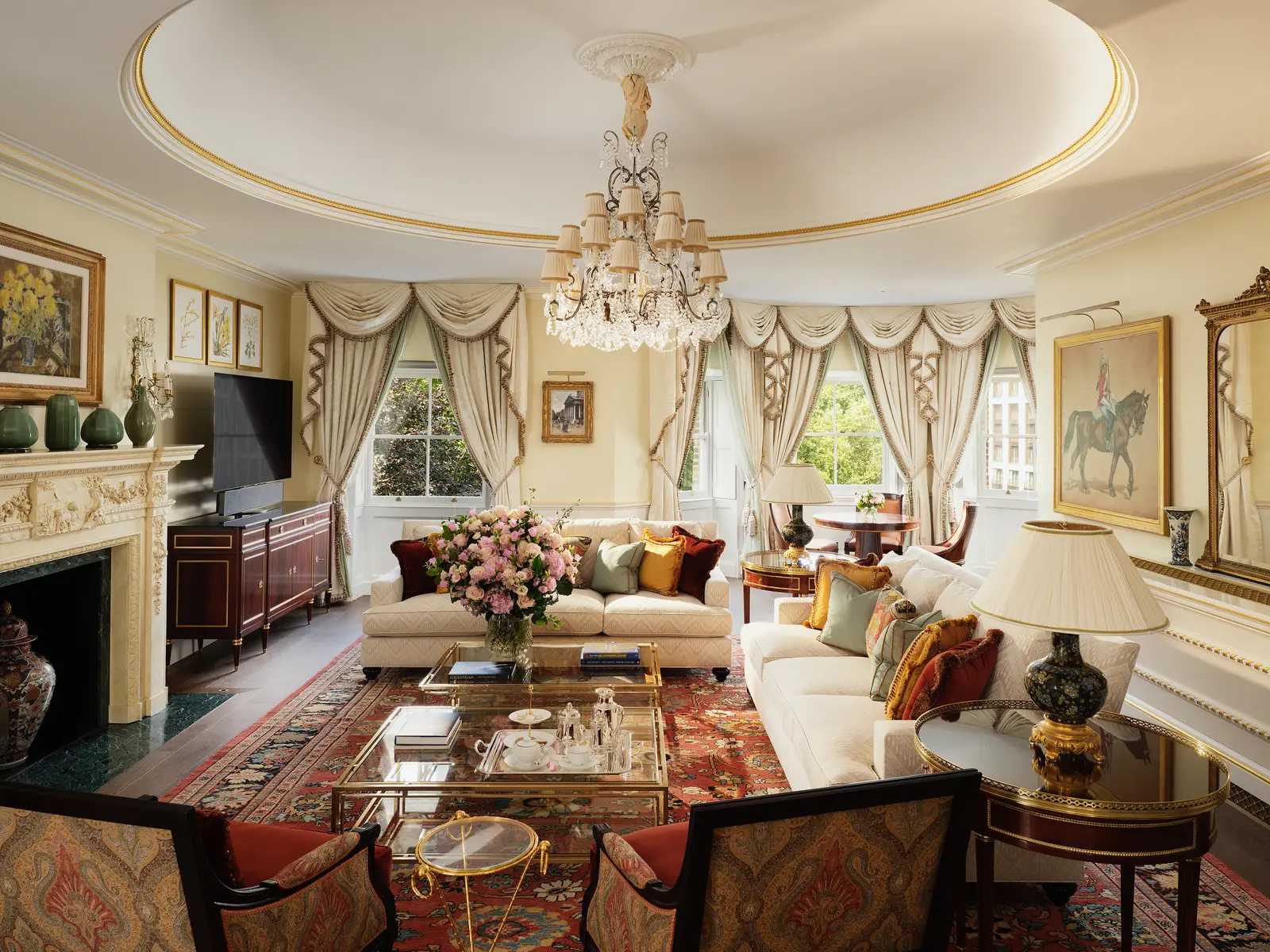 The Prince of Wales Suite’s lounge: a domed ceiling, a chandelier, a fireplace and sofas on a floral rug