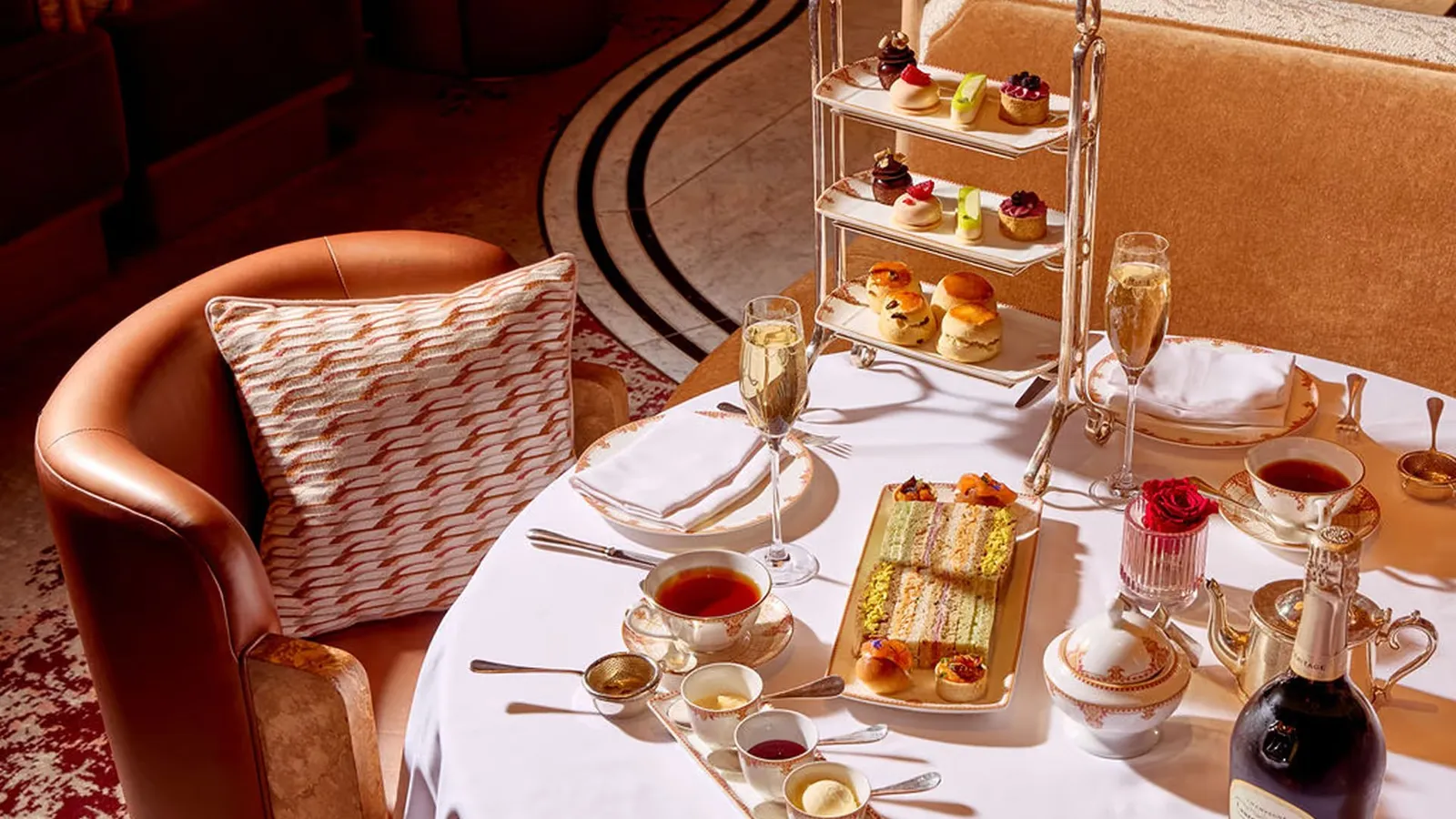 An afternoon tea table in Gallery: the stand, sandwiches, tea and Champagne