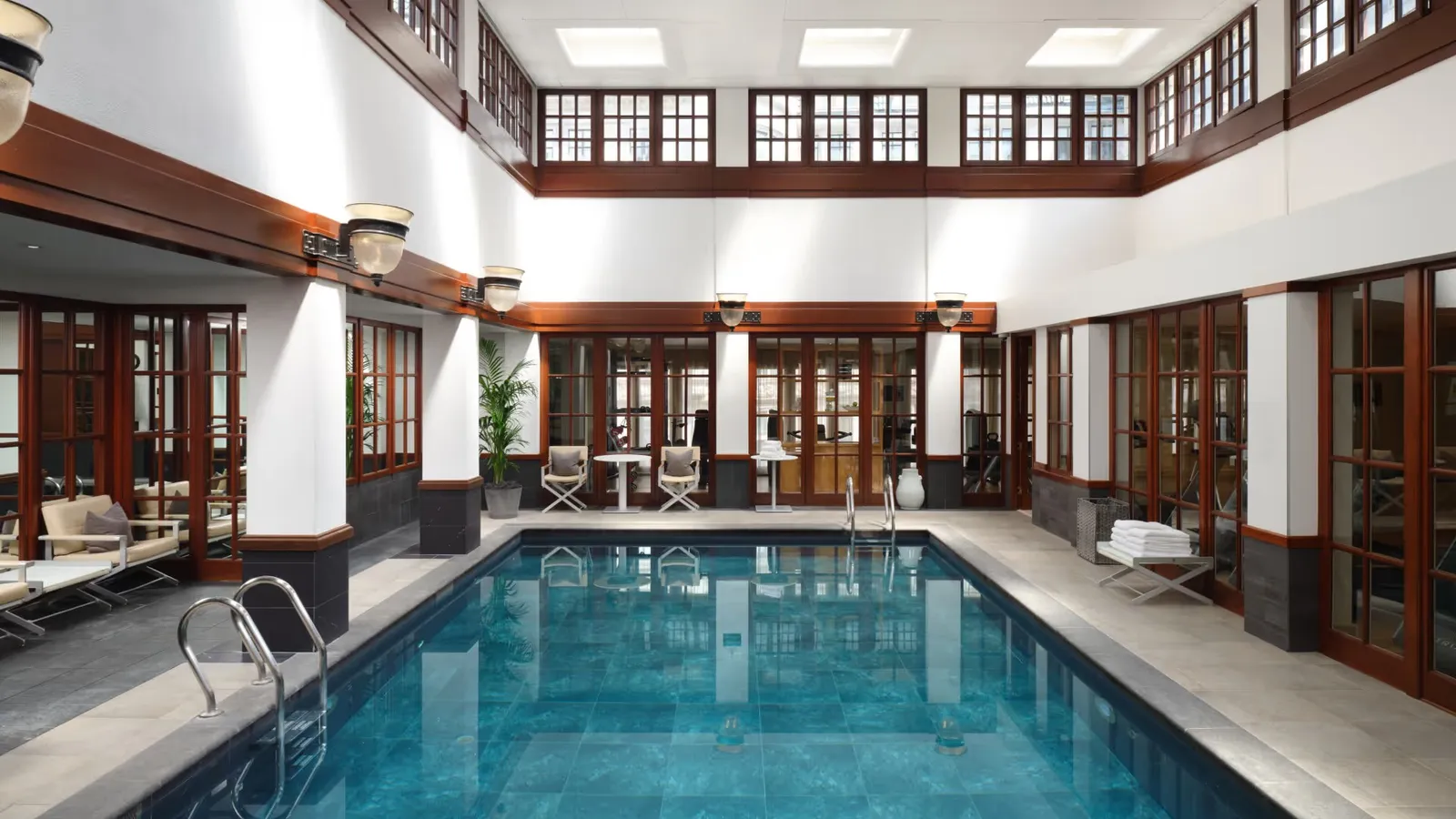 The indoor pool under the skylight, with loungers along the edge