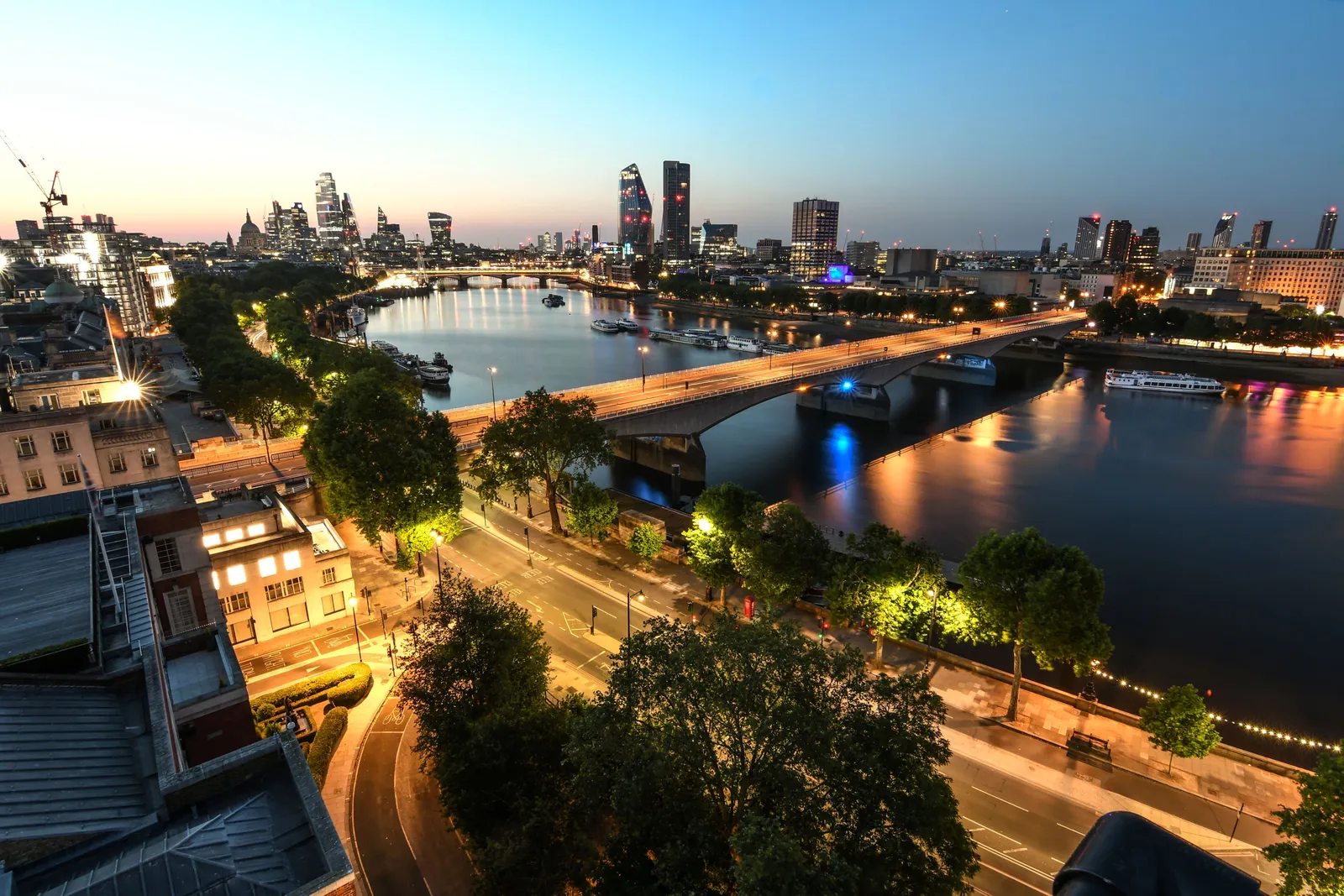 The Thames at dawn seen from the Savoy, with the bridge, the Embankment and the towers of the City