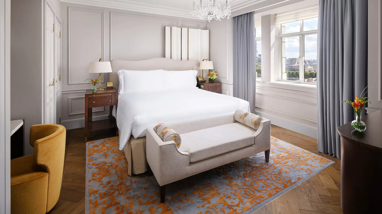 One Bedroom Partial River View Suite: the bedroom with its king bed and window