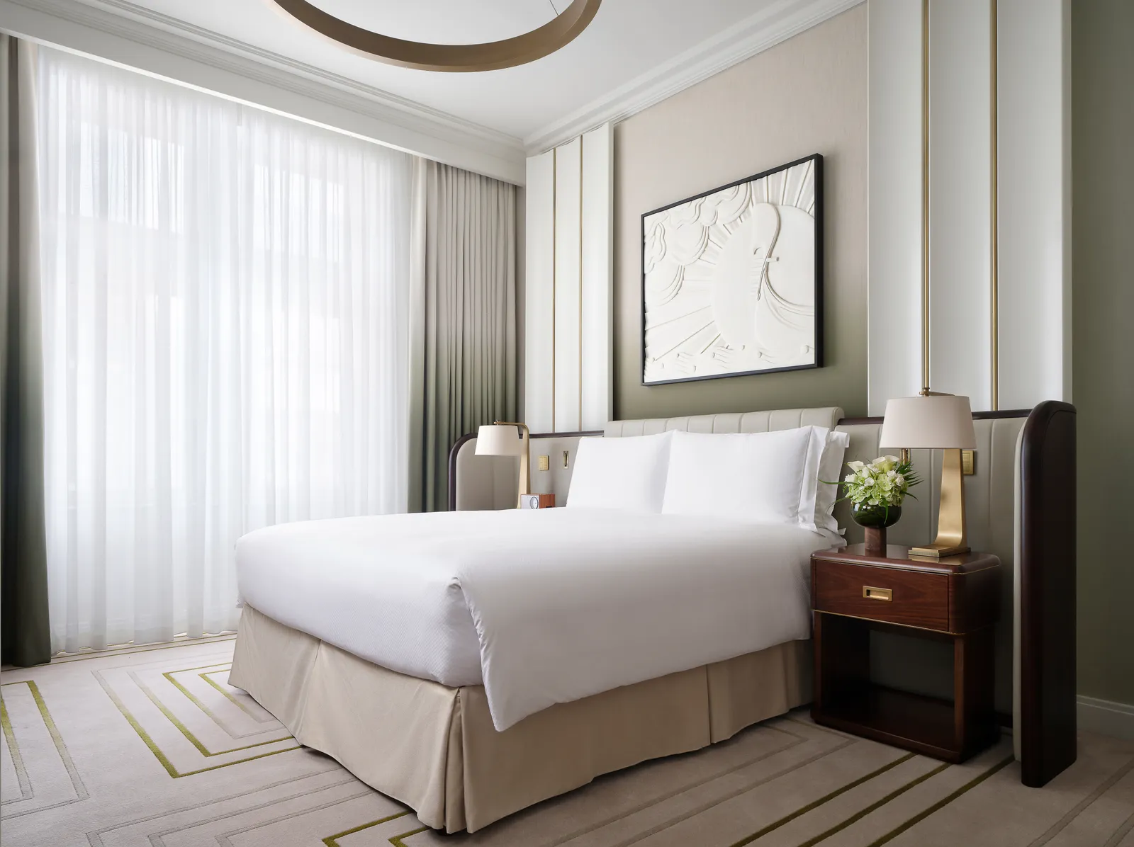 Superior Queen Room: a queen bed and tall curtained windows