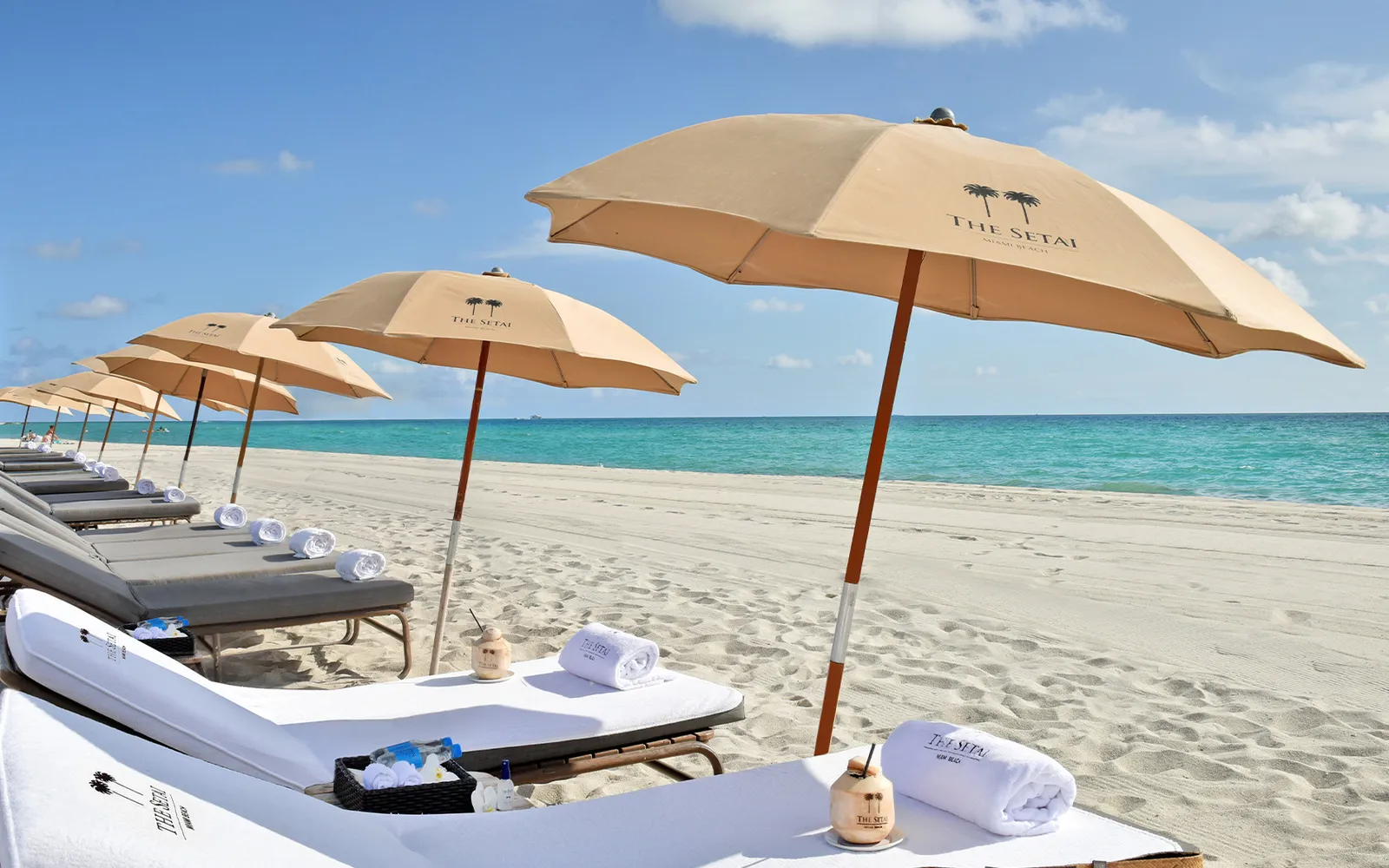 The hotel’s loungers and sand-coloured umbrellas on the white beach, the turquoise sea beyond.