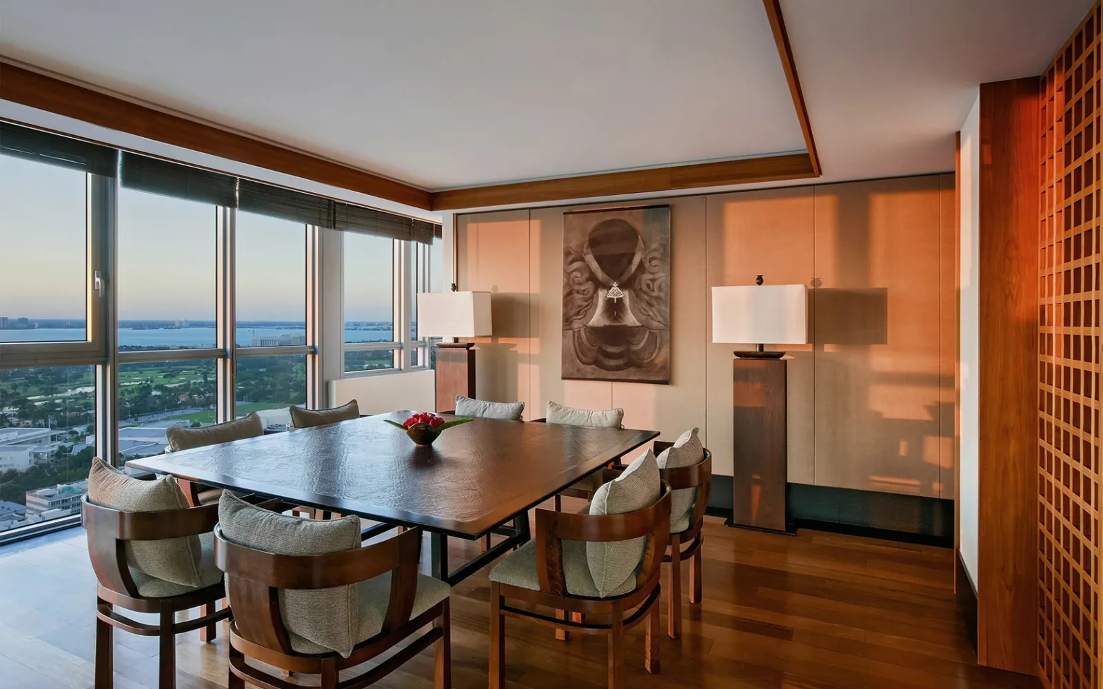 The Grand Suite’s dining room, with a table for 8, a stone mask on the wall and a view over the bay.