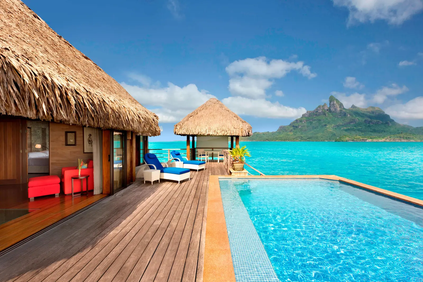 The deck of an Overwater Royal villa, its pool and Mount Otemanu across the lagoon