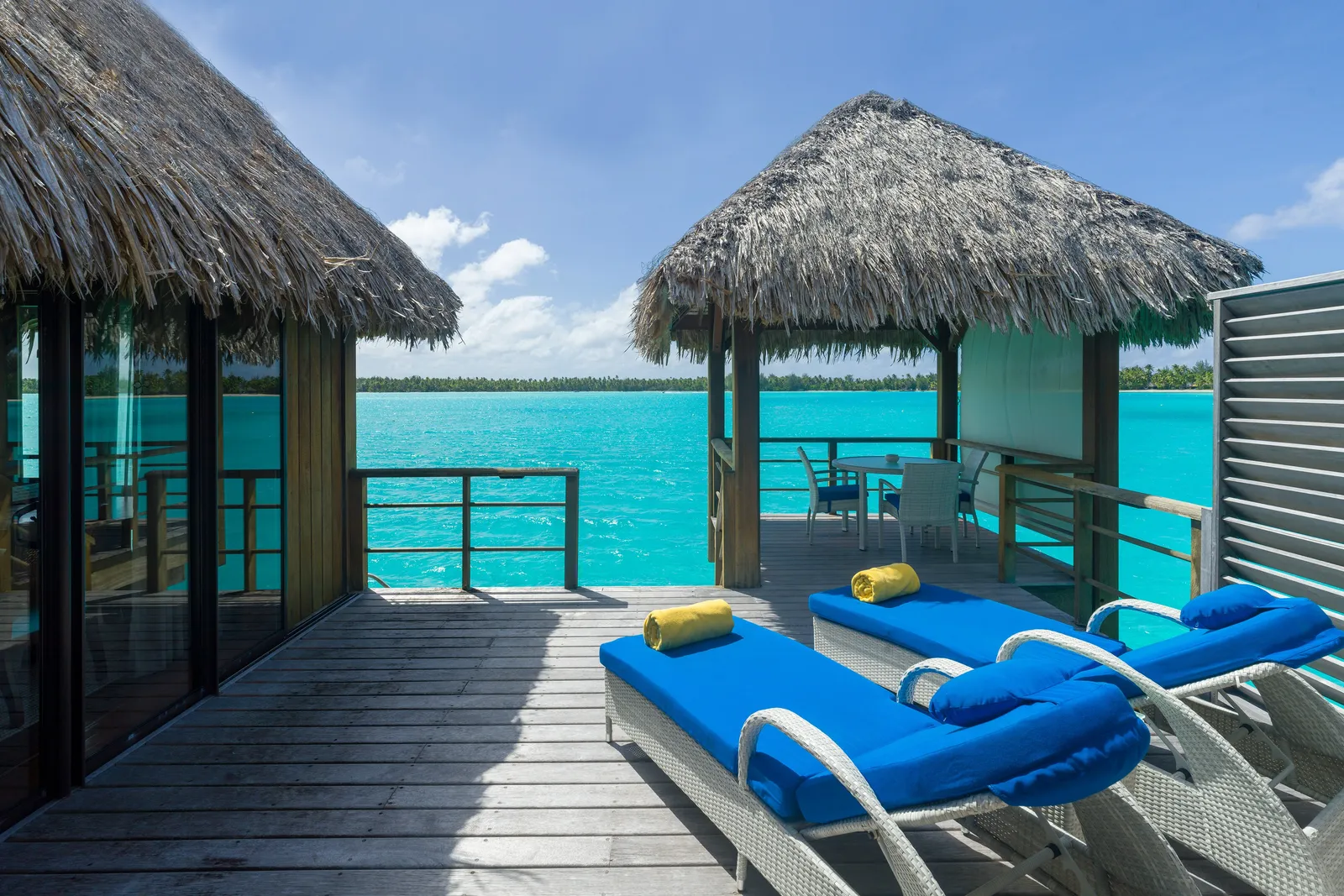 The deck of an Overwater Superior with loungers and a gazebo over the lagoon