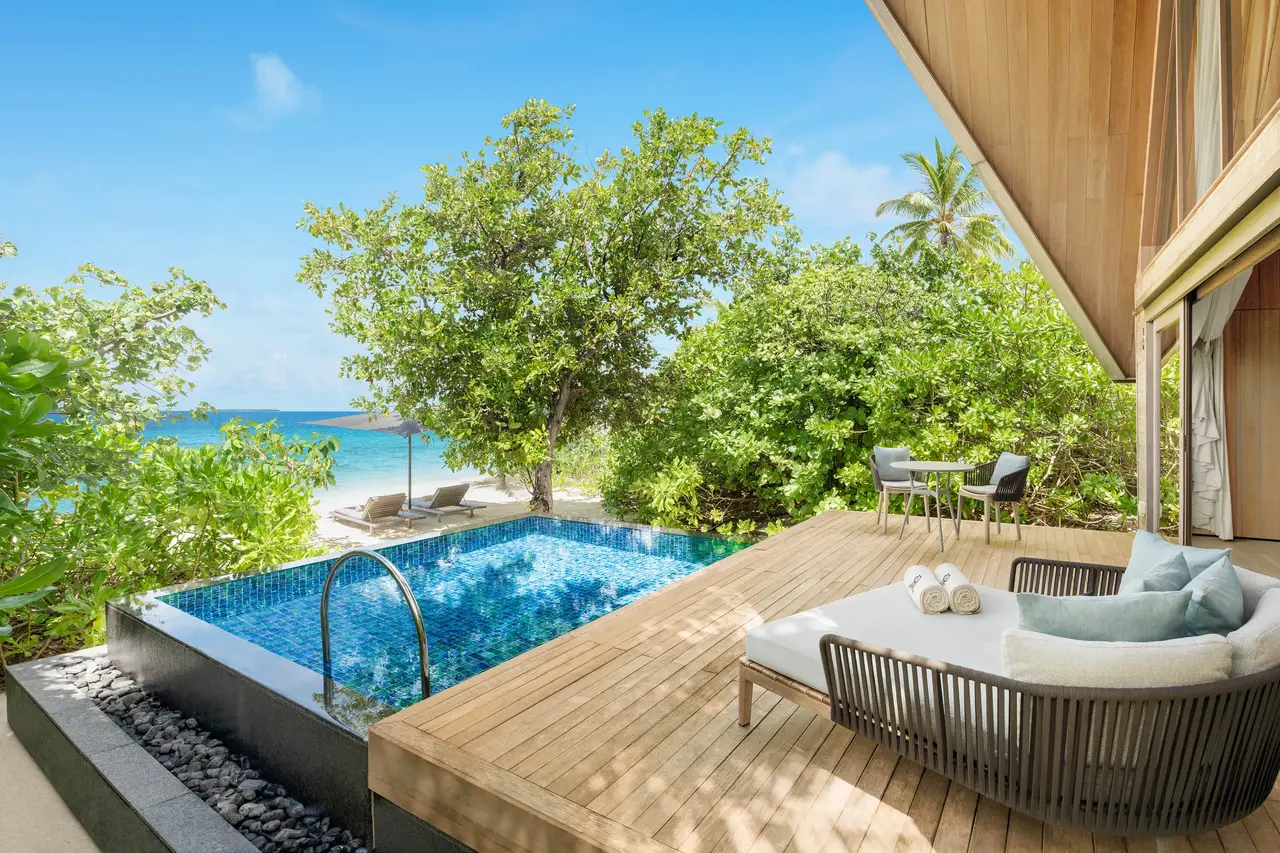 A Beach Villa’s covered terrace and pool, with the beach beyond the plants