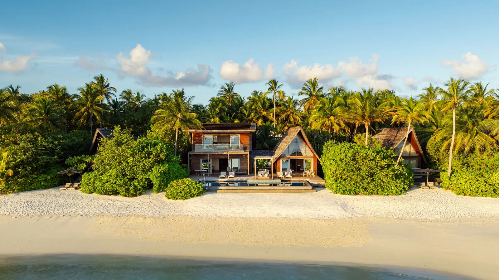 The Cesar Balsa Villa seen from the beach, among the palms