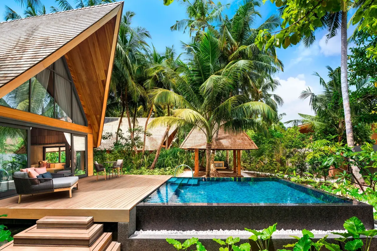 The Garden Villa pool among the palms, with its timber deck