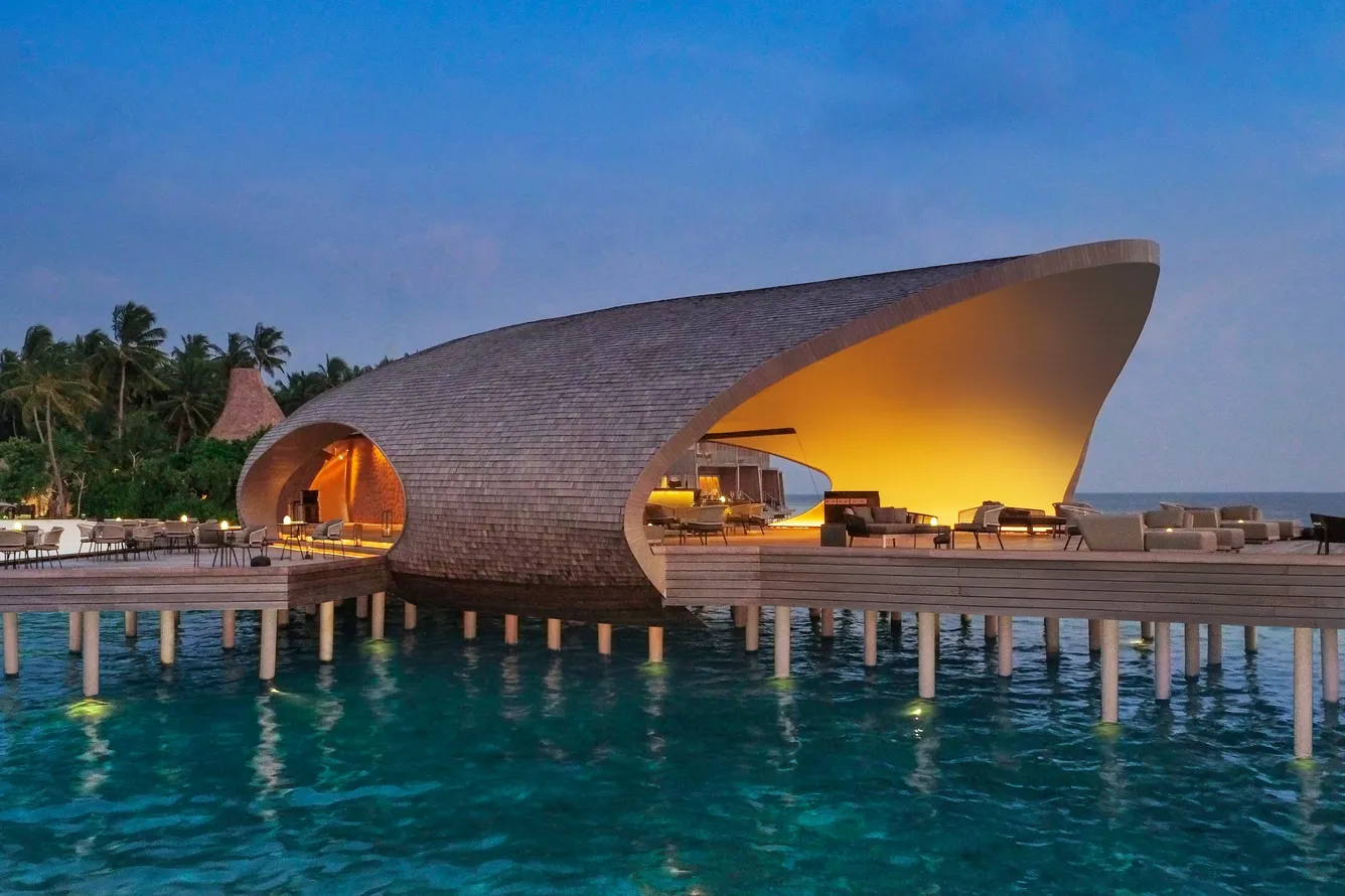 The Whale Bar on its stilts, lit at dusk