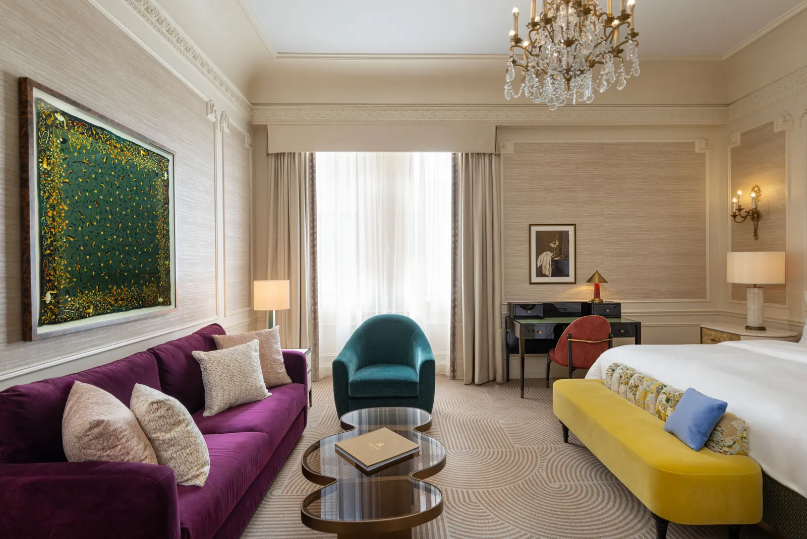 Grand Luxe room with a violet sofa and a yellow bench at the foot of the bed
