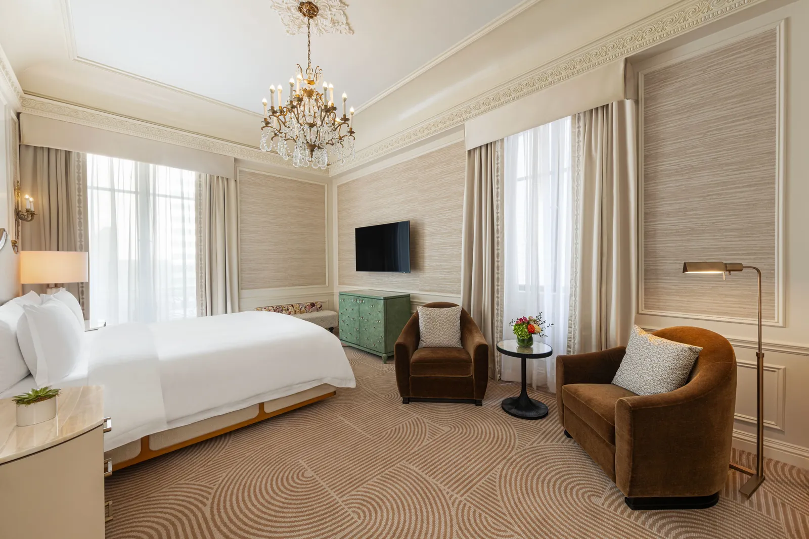 The Madison Suite bedroom with a chandelier