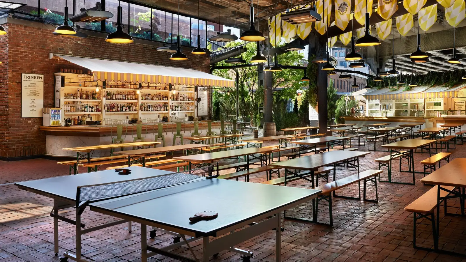 The Biergarten under the High Line’s tracks, long tables and a ping-pong table