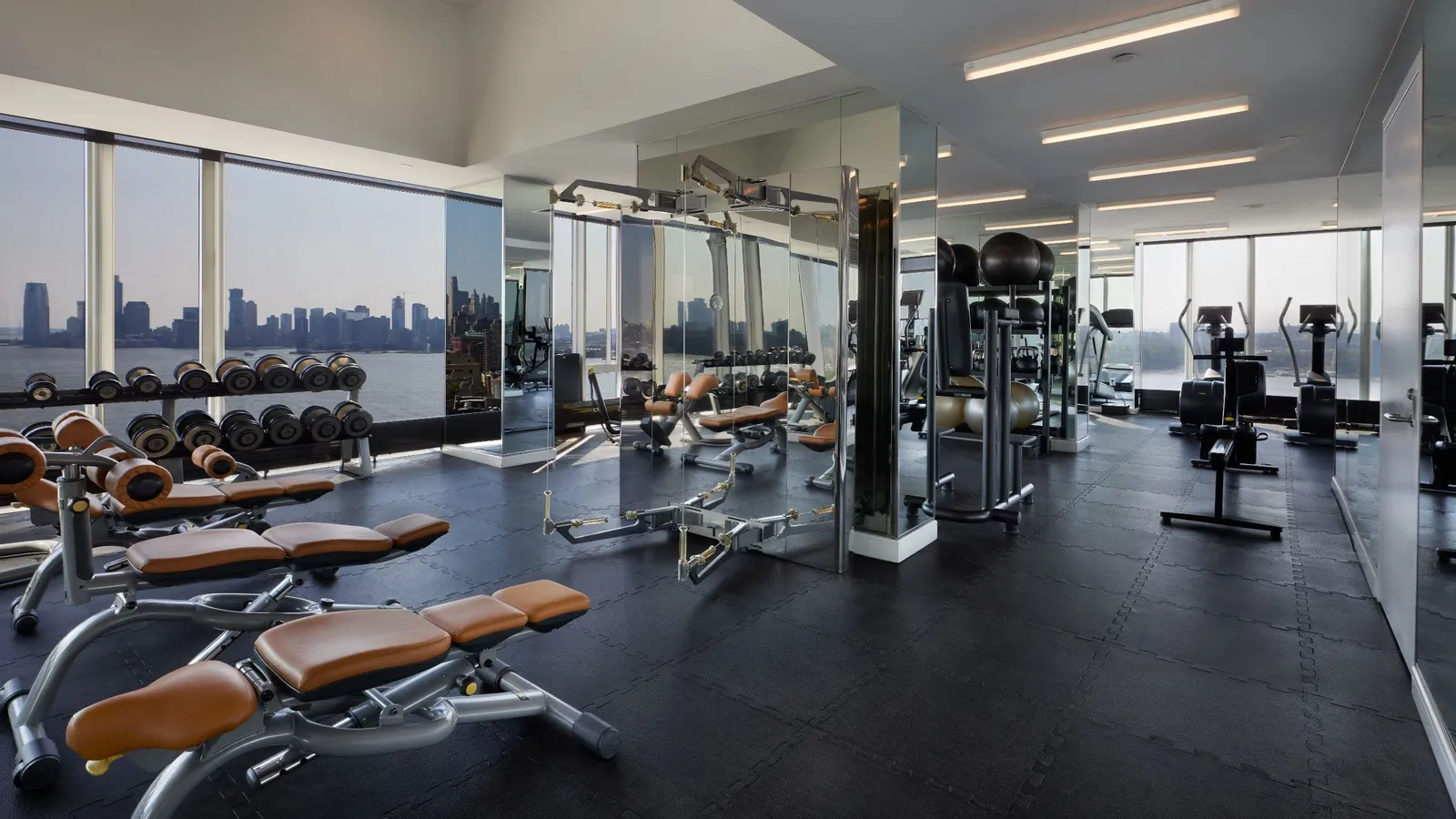 The gym with weights and treadmills facing the Hudson