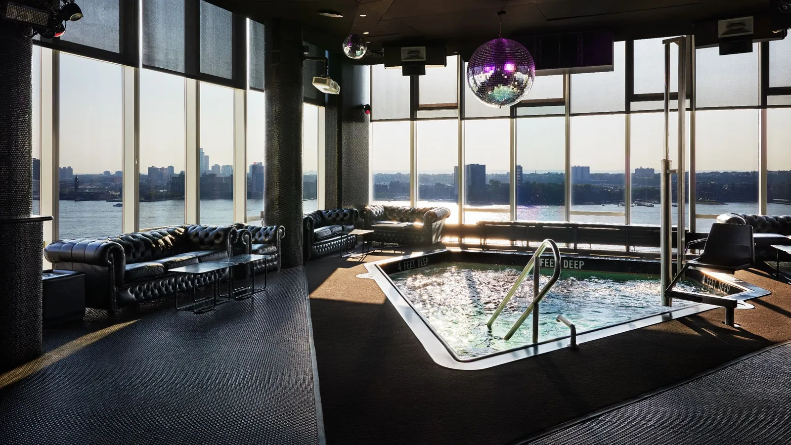 Le Bain’s plunge pool among leather sofas, the Hudson beyond the glass