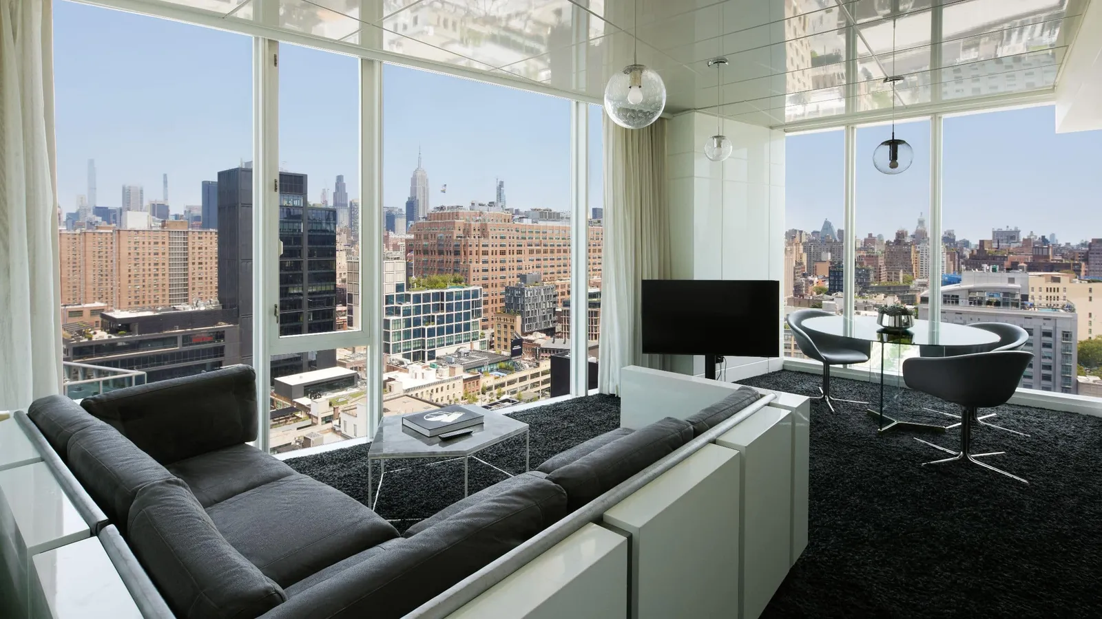The Empire Suite living room, the grey sofa facing Midtown’s towers