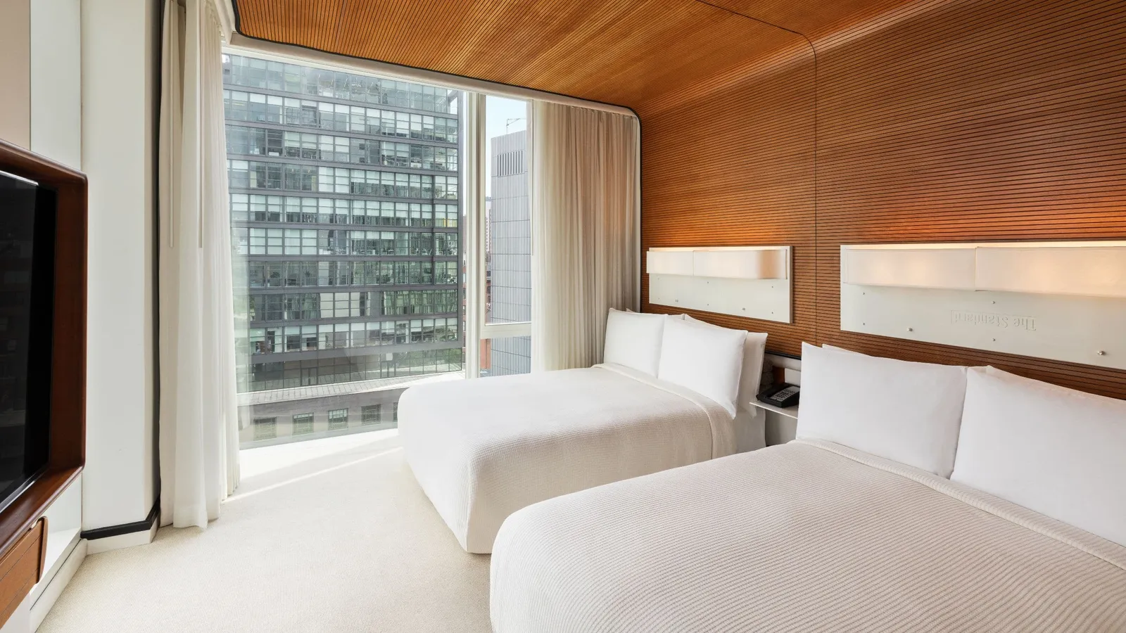 The Standard Double with 2 white beds under the timber wall