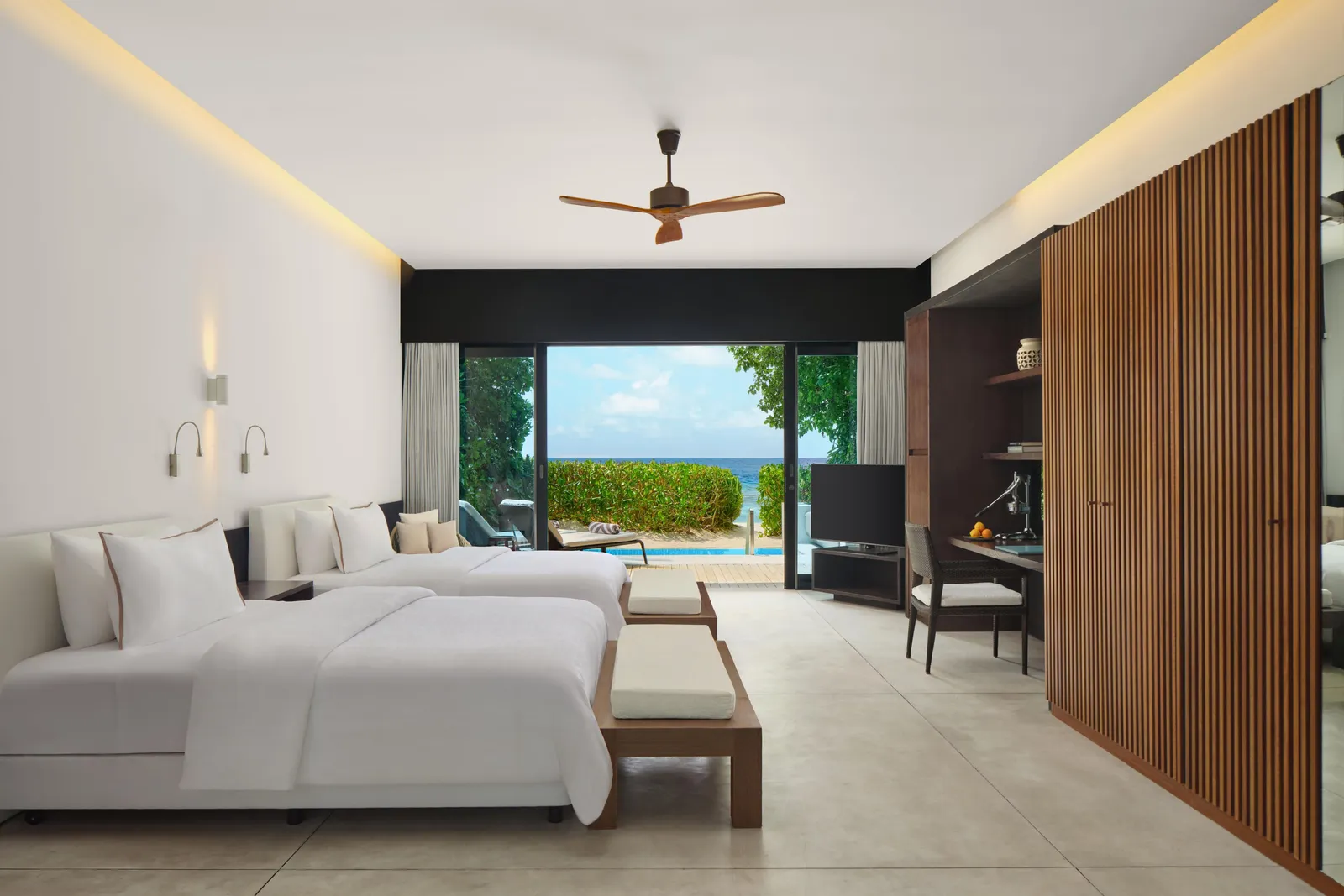 The Family Beach Villa – Pool, 2 double beds side by side and the glass opening on the garden and the beach.