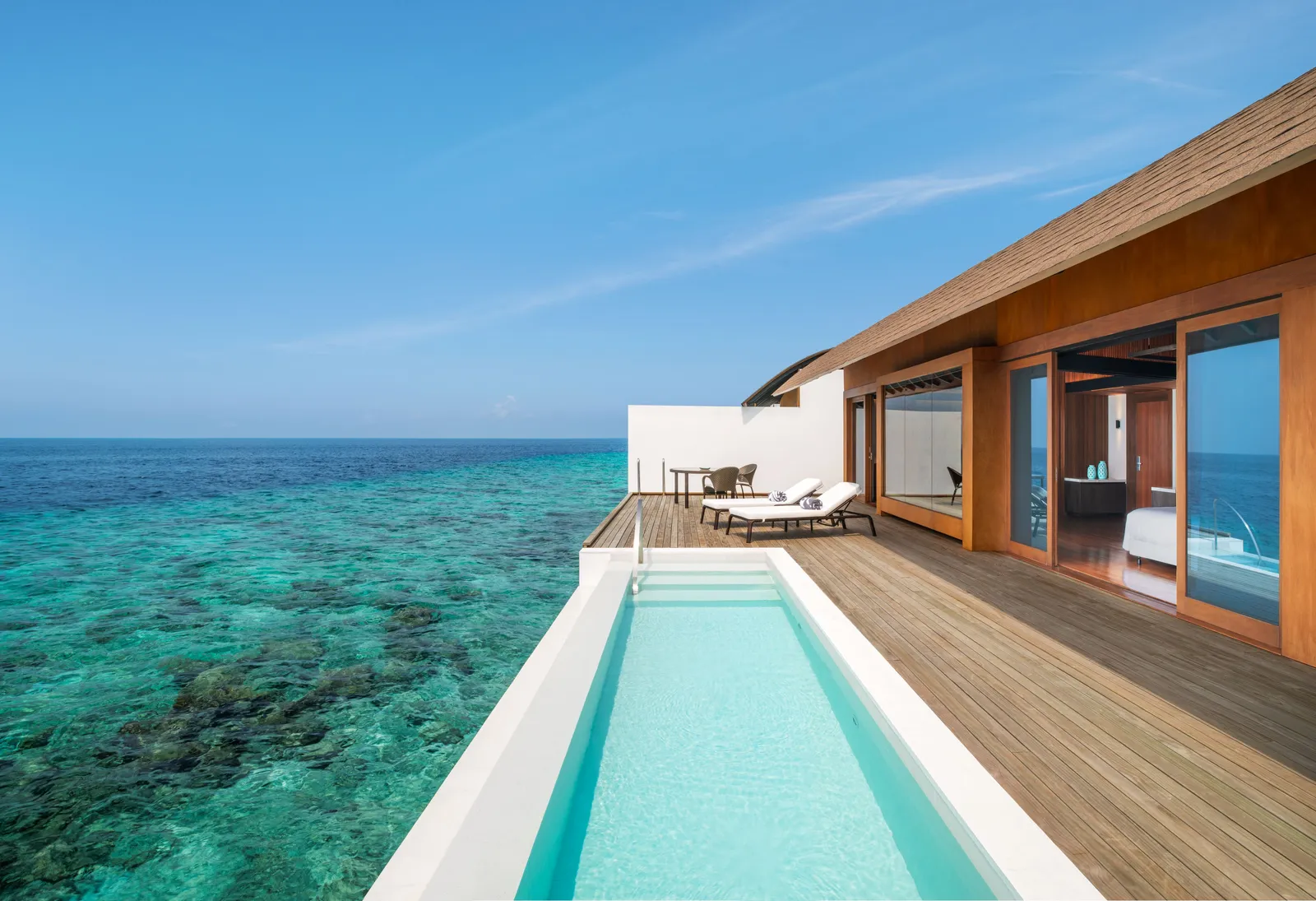 An Overwater Villa – Pool deck: the long private pool and the timber deck above the clear reef.
