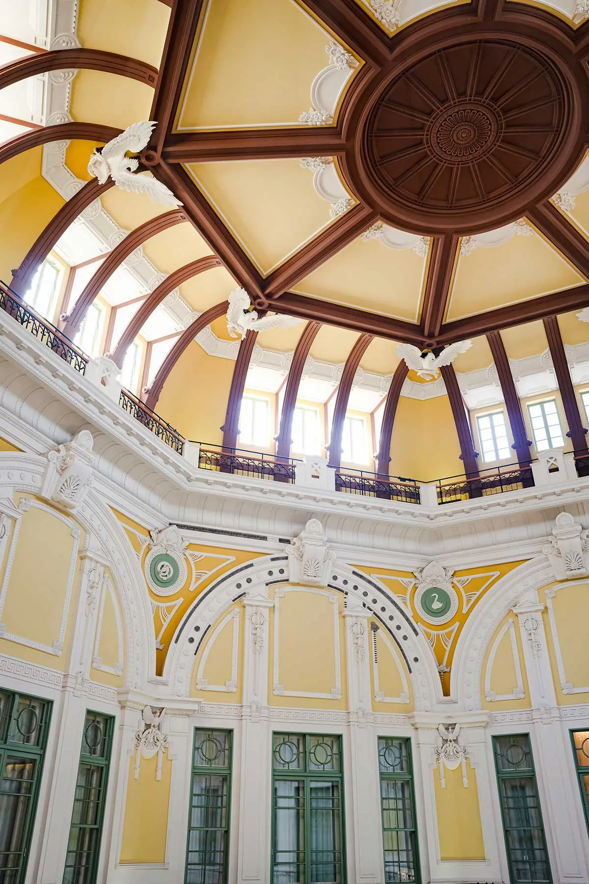 Inside one of the station’s domes from below: the white and yellow reliefs, the dark ribs and the green windows.