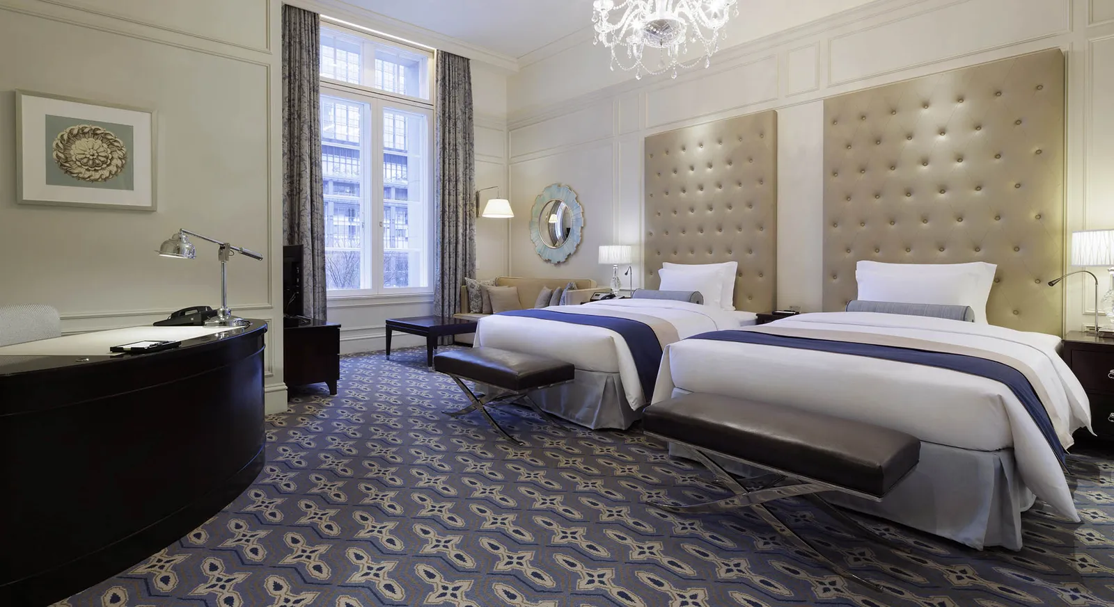 A Palace View twin, with its tall padded headboards, the chandelier and the tall window.