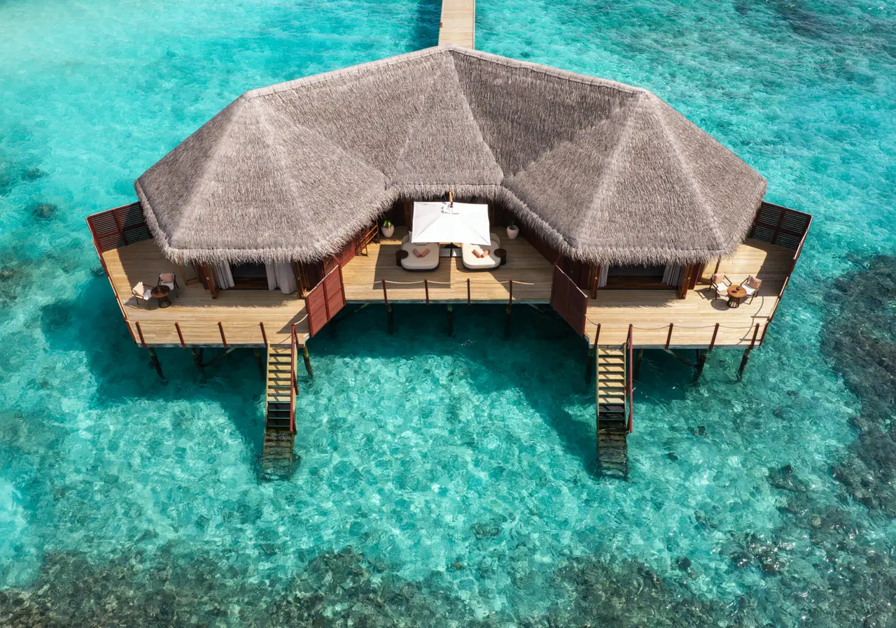 The Two Bedroom Overwater Villa from above: the 2-winged thatched roof, the 2 decks and 2 ladders onto the reef.