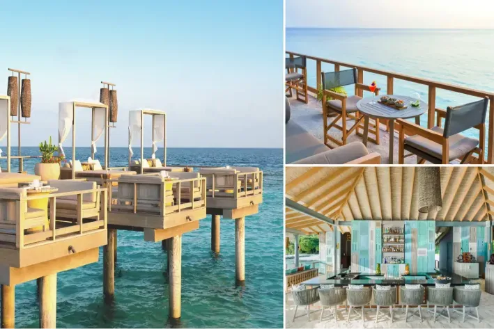 Lagoon Bar on its stilts: day beds above the water, a table over the lagoon and the bar.