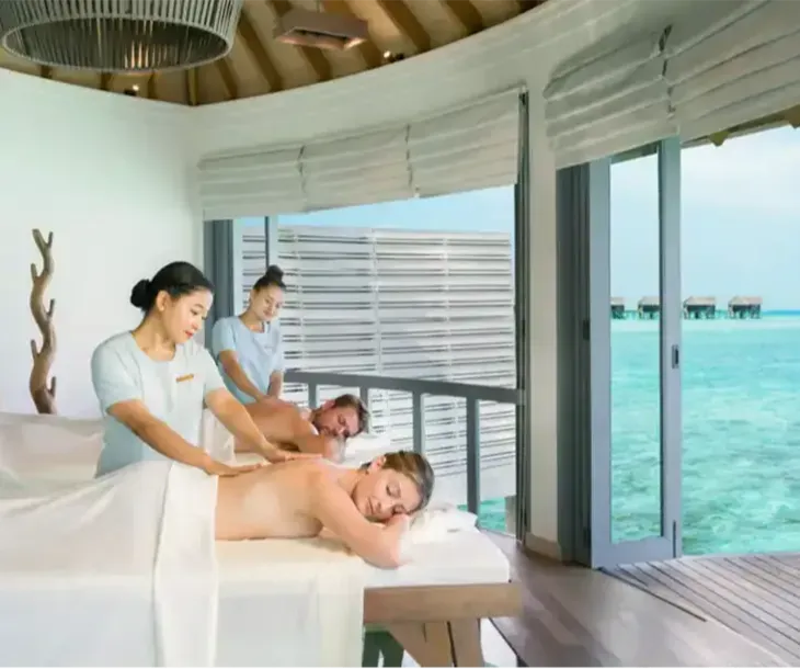 A couple’s massage at Merana Spa, in an overwater pavilion open to the lagoon.