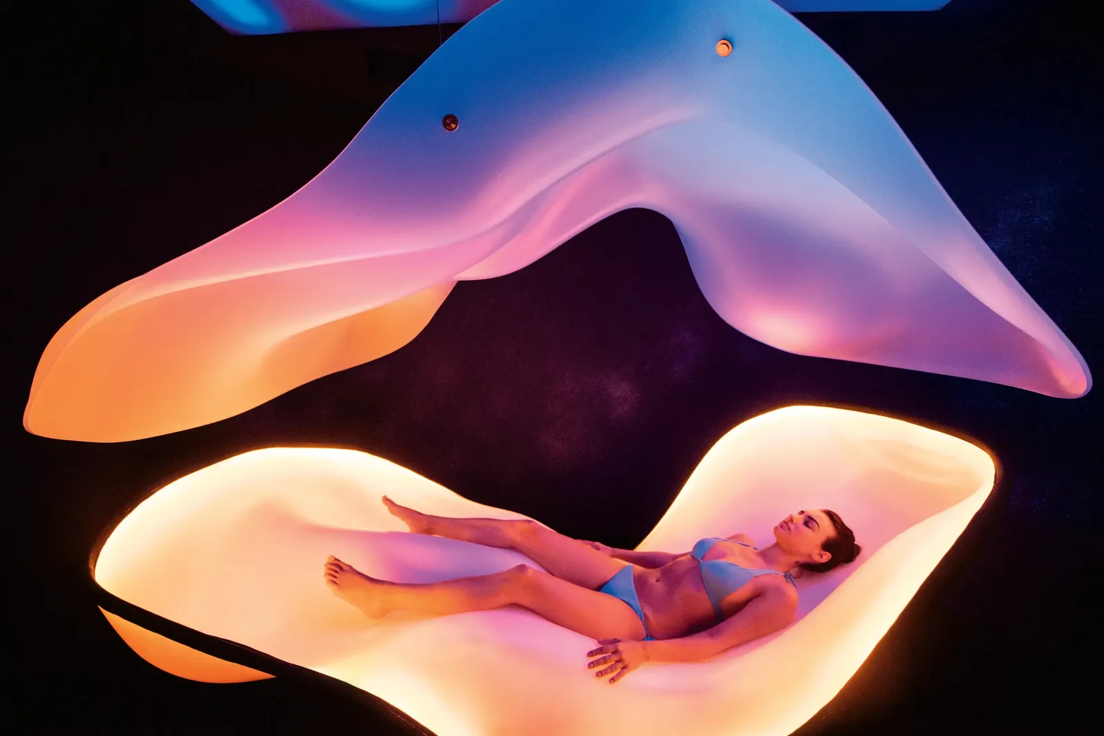 The spa’s Cloud 9: a lounger suspended in a shell of pink and violet light