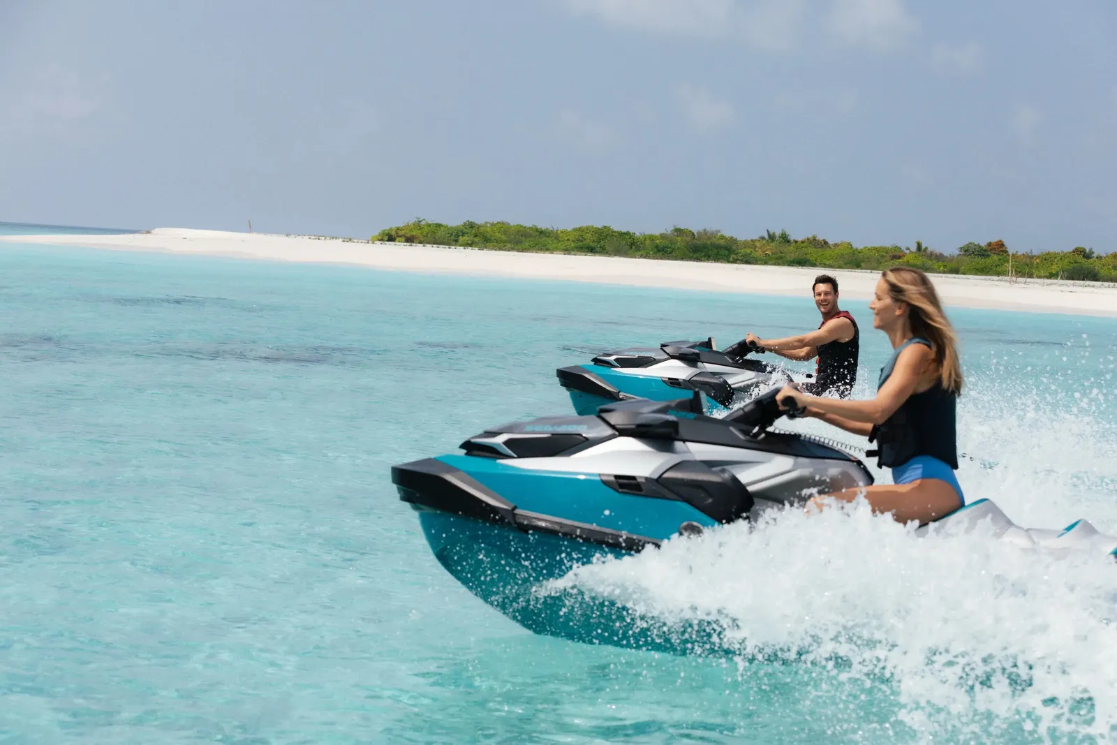 2 people on a jet ski across the turquoise lagoon