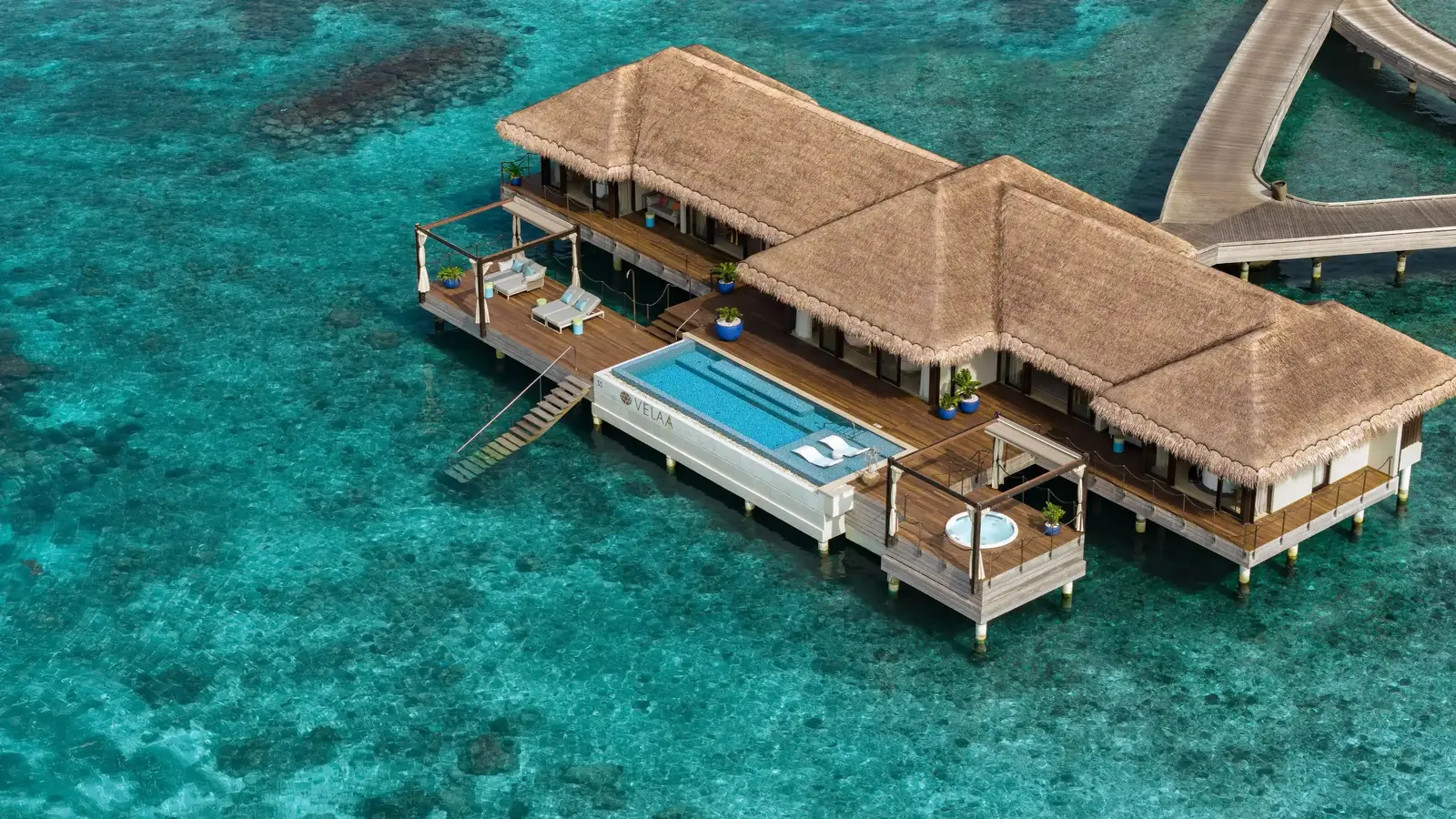 The Ocean Pool House from the air, alone over the water at the tip of the island