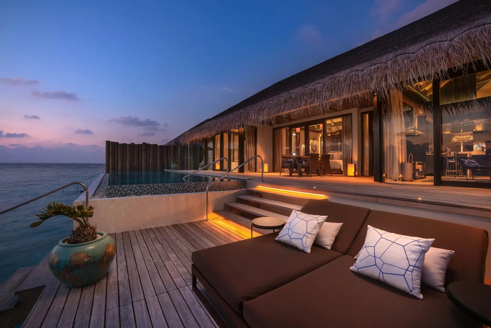 Sunset Deluxe Water Pool Villa at sunset: the deck and pool lit up