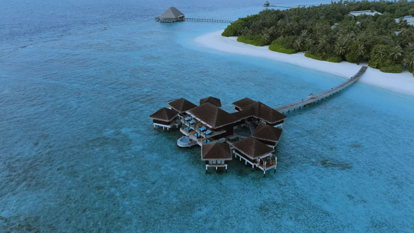 The spa over the water from the air, its pavilions in a line along the jetty